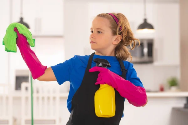 Cleaning house. Portrait of child cleaning, concept growth, development, family relationships. Housekeeping and home cleaning concept. Child use duster and gloves for cleaning