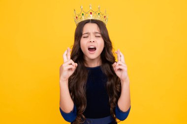 Teen child in queen crown isolated on yellow background. Princess girl in tiara. Teenage girl wear diadem