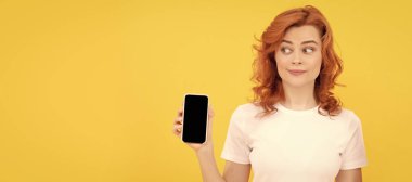 Woman isolated face portrait, banner with mock up copy space. amazed woman showing credit or debit card and smartphone to make online shopping, online business