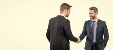 two businessmen colleagues shaking hands after successful business deal, cooperation. Man face portrait, banner with copy space