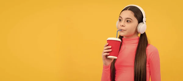 Serious Child Listen Music Headphones Drink Paper Cup Yellow Background — Φωτογραφία Αρχείου
