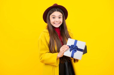 Mutlu genç sonbahar portresi. Mutlu kız yüzü, pozitif ve gülümseyen duygular. Hediye kutusu olan ergen bir çocuk. Genç kız doğum günü hediyesi veriyor. Hediye, selam ve hediye konsepti. Gülümseyen kız