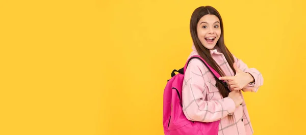 stock image back to school. surprised teen girl in checkered shirt. happy kid casual style carry backpack. Banner of school girl student. Schoolgirl pupil portrait with copy space