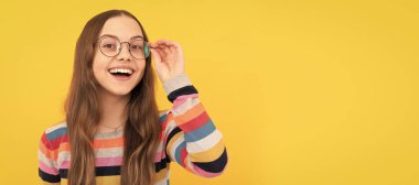 happy schoolgirl nerd kid in eyeglasses for vision, eyesight. Child face, horizontal poster, teenager girl isolated portrait, banner with copy space