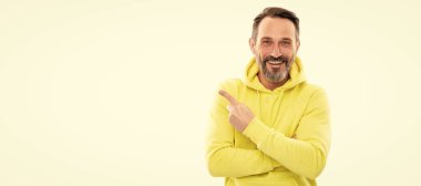 look here. adult guy advertising. male casual sporty fashion. copy space. happy man pointing finger. Man face portrait, banner with copy space