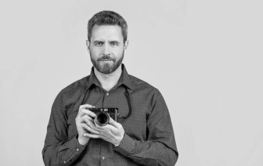 A life well captured. Bearded man hold photo camera. Photographic equipment. Visual art. Professional photography. Photographic studio, copy space.