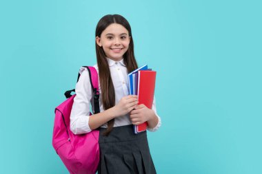 School girl teenager child with book and copybook. Teenager schoolgirl student with backpack, isolated background. Learning and knowledge education concept