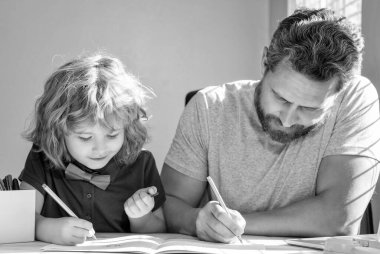 father and son painting at home. family help. boy do homework with teacher. private writing lesson. education concept. homeschooling and self-education. back to school.