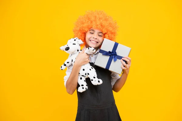stock image Emotional teenager child hold gift on birthday. Funny kid girl holding gift boxes celebrating happy New Year or Christmas. Happy girl face, positive and smiling emotions
