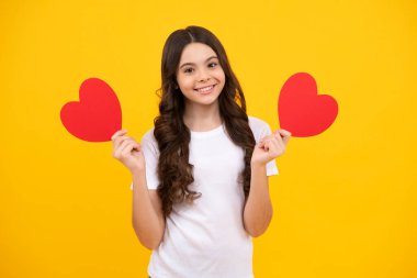 Mutluluk çocuklar ve aşk konsepti. Kırmızı kalpli romantik genç kız, dünya kalbi günü, mutlu sevgililer günü. Mutlu ergen, pozitif ve gülümseyen genç kız duyguları