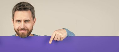 Man face portrait, banner with copy space. guy make announcement. male behind paper sheet. place for useful information. copy space