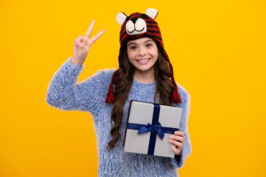 İzole edilmiş arka planda hediye kutusu olan çocuk. Doğum günü hediyeleri, sevgililer günü, yeni yıl ya da Noel. Mutlu ergen, pozitif ve gülümseyen genç kız duyguları