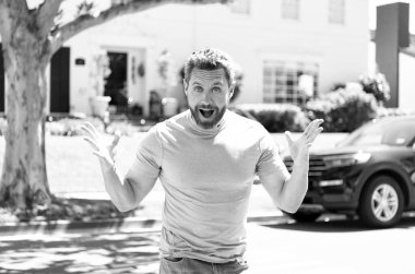 happy unshaven man with amazed face gesturing in feeling of amazement, surprise.