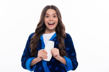 Teenager child girl with bottle shampoo conditioners or shower gel. Kids hair care. Hair cosmetic product, shampoo bottle. Happy girl face, positive and smiling emotions