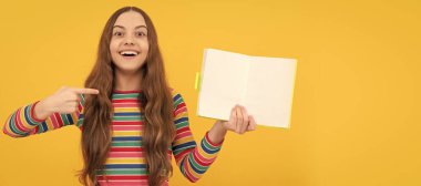 Going back-to-school on September 1. Happy child point finger at open book. Banner of schoolgirl student. School child pupil portrait with copy space