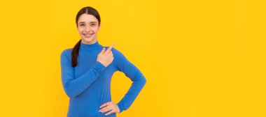 Neşeli kadın fotokopi uzayı işaret ediyor. Güzellik ve moda. Kadın manken. İzole edilmiş yüz portresi, afiş başlığı posteri ve kopyalanmış kopya alanı