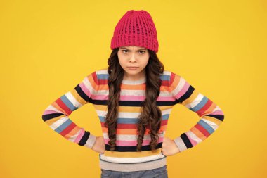 Winter hat. Cold season concept. Winter fashion accessory for children. Teen girl wearing warm knitted hat. Unhappy sad teenager girl