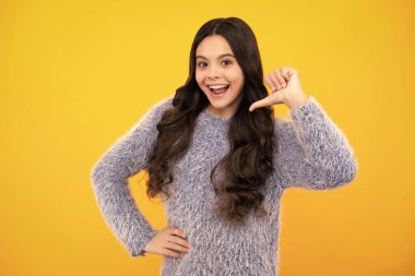 Happy teenager, positive and smiling emotions of teen girl. Teenager child girl point thumb herself. Choose me. Girl pointing at herself. Me, myself and I