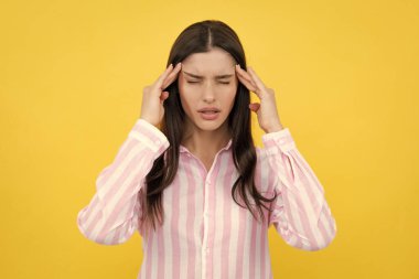 Portrait of young woman feeling stress or strain headache. Exhausted tired girl desperate and stressed because pain and migraine