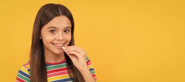 girl eat multivitamin. healthy lifestyle. childhood health. food supplement. Horizontal poster of isolated child face, banner header, copy space