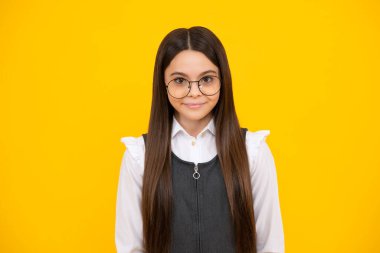 Headshot portrait of teenager child girl isolated on studio background. Childhood lifestyle concept. Mock up copy space. Happy girl face, positive and smiling emotions