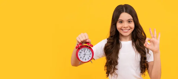 punctuality. happy kid hold alarm clock. last chance. time for shopping sales. good morning. Teenager child with clock alarm, horizontal poster. Banner header, copy space