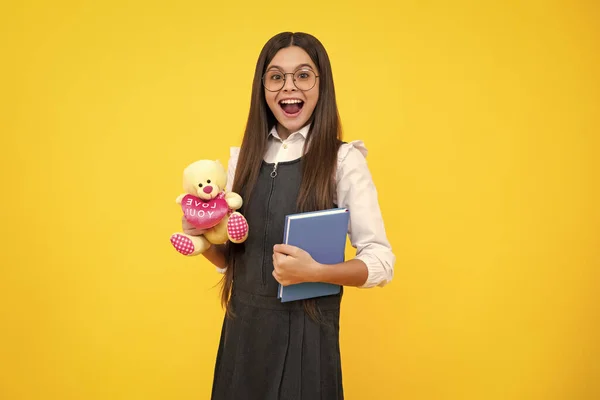 Funny school girl with toy. Happy childhood and kids education. Knowledge day. Excited face, cheerful emotions of teenager girl