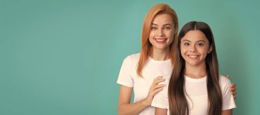 Mother and daughter child banner, copy space, isolated background. loving mother hug daughter in white shirts on blue background, family