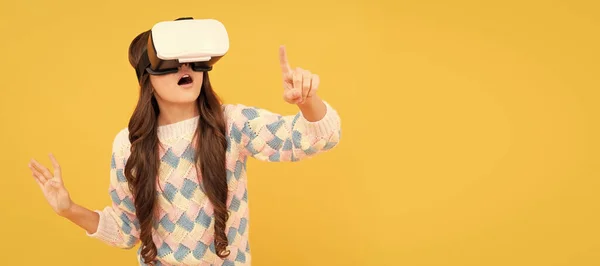amazed teen girl wear vr glasses using technology for education in virtual reality, virtual world. Banner of child girl with virtual reality vr headset, studio portrait with copy space