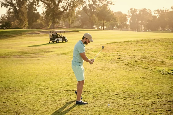 professional sport outdoor. male golf player on professional golf course. portrait of golfer in cap with golf club. people lifestyle. concentrated guy playing game on green grass. summer activity.