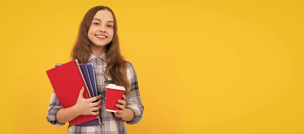 cheerful teen girl in checkered shirt holding coffee cup and notebook. Banner of schoolgirl student. School child pupil portrait with copy space