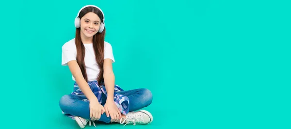 Time to learn more. childhood development. child in modern earphones. Child portrait with headphones, horizontal poster. Girl listening to music, banner with copy space