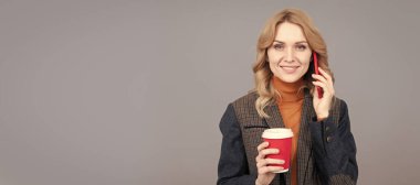 Woman talk on phone drinking coffee. Caffeine and smartphone addiction. Addiction to technology. Woman portrait, isolated header banner with copy space