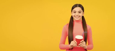 happy child with takeaway coffee cup on yellow background, morning. Horizontal poster of isolated child face, banner header, copy space
