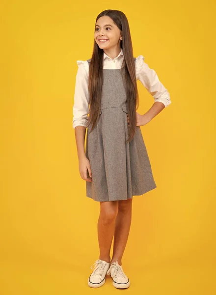 School uniform. Elegant fashion teenager child girl posing in studio. Trends kids clothes