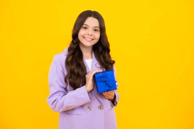 Teenager child with gift box. Present for holidays. Happy birthday, Valentines day, New Year or Christmas. Kid hold present box. Happy teenage girl, positive and smiling emotions
