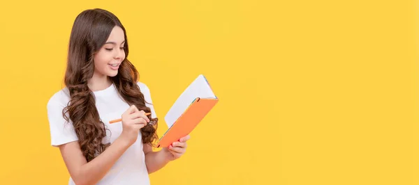 smiling school teen girl ready to study making notes in planner, education. Horizontal isolated poster of school girl student. Banner header portrait of schoolgirl copy space