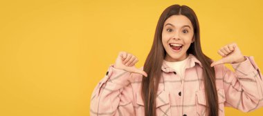 happy kid girl wear pink checkered shirt pointing fingers on herself, selfish. Child face, horizontal poster, teenager girl isolated portrait, banner with copy space