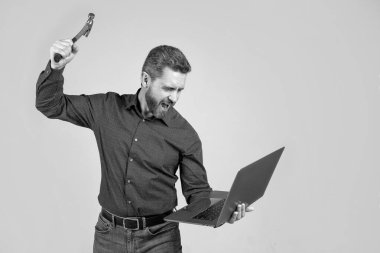 Öfkeni bilgisayarda serbest bırakıyorsun. Stresli adam bağırıyor ve çekiçle dizüstü bilgisayar kırıyor. Bilgisayar arızası. Teknolojinin olumsuz etkisi. Stres yaptım..