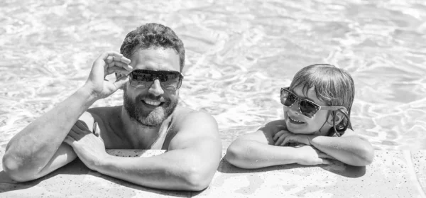 happy family of daddy and son having fun in summer swimming pool, vacation.