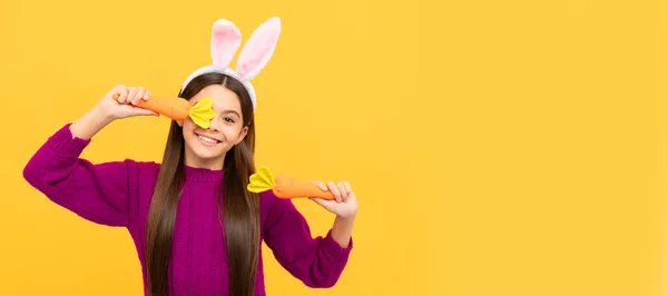 lets play. happy teen girl wear bunny ears hold carrot. Easter child horizontal poster. Web banner header of bunny kid, copy space