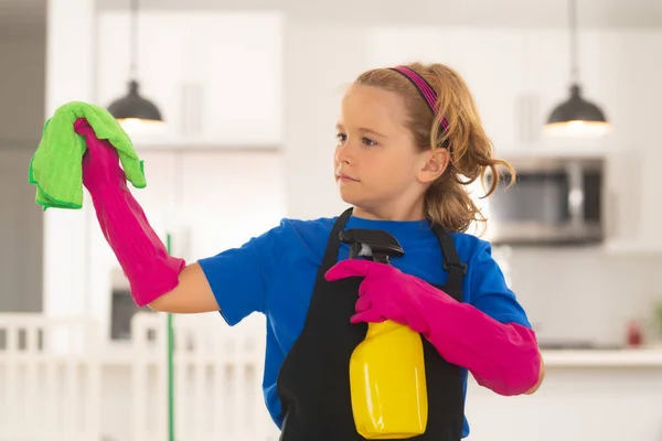 Cleaning house. Child cleans at home concept. Kid cleaning with mop to help with housework. Little cute boy sweeping and cleaning, on kitchen background