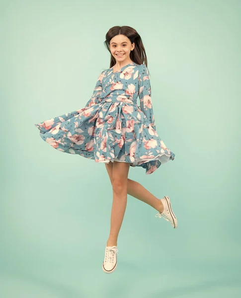 Amazed expression, cheerful and glad. Full length little overjoyed teen girl 12, 13, 14 year old jump and run isolated on blue background studio. Excited teenager, amazed and cheerful emotions