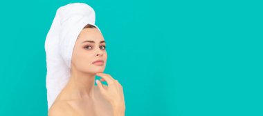 woman touch her perfect skin on blue background. Beautiful woman isolated face portrait, banner with mock up copy space