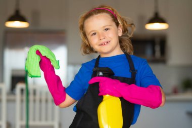 Cleaning house.Children helping with housekeeping, cleaning the house. Housekeeping at home. Cute child boy helping with housekeeping on kitchen interior backdround