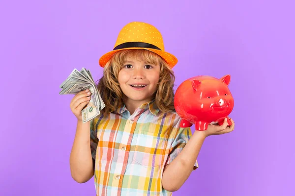 Cash money dollars bills and piggy bank concept. Boy saving money in a piggybank. Child boy with american dollars money