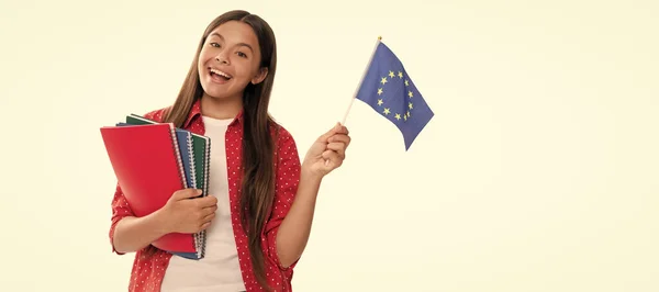 child hold european union flag and school copybook for studying isolated on white, education. Portrait of schoolgirl student, studio banner header. School child face, copyspace