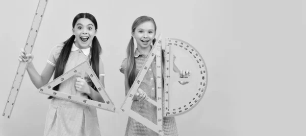 School girls friends. Happy teen girls hold geometric tools. School education. Learn and grow together. Banner of school girl student. Schoolgirl pupil portrait with copy space