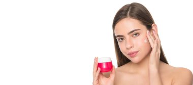 presenting female cosmetic product. woman applying face cream. young girl hold face mask. Woman beauty face, close up portrait, isolated banner with copy space