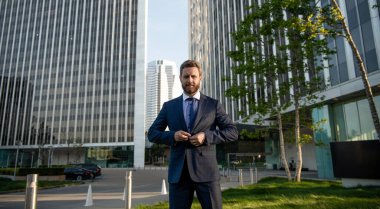 business success. successful man in businesslike suit. entrepreneur outside the office. male formal fashion. professional unshaven ceo. mature businessperson in formalwear.
